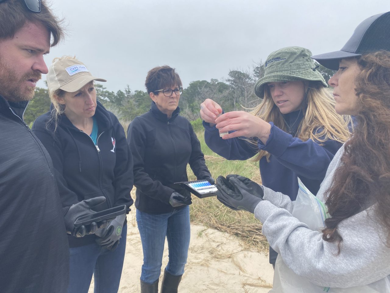 Coastal Specialist Georgia Busch works with a group of volunteers who are doing water quality testing.
