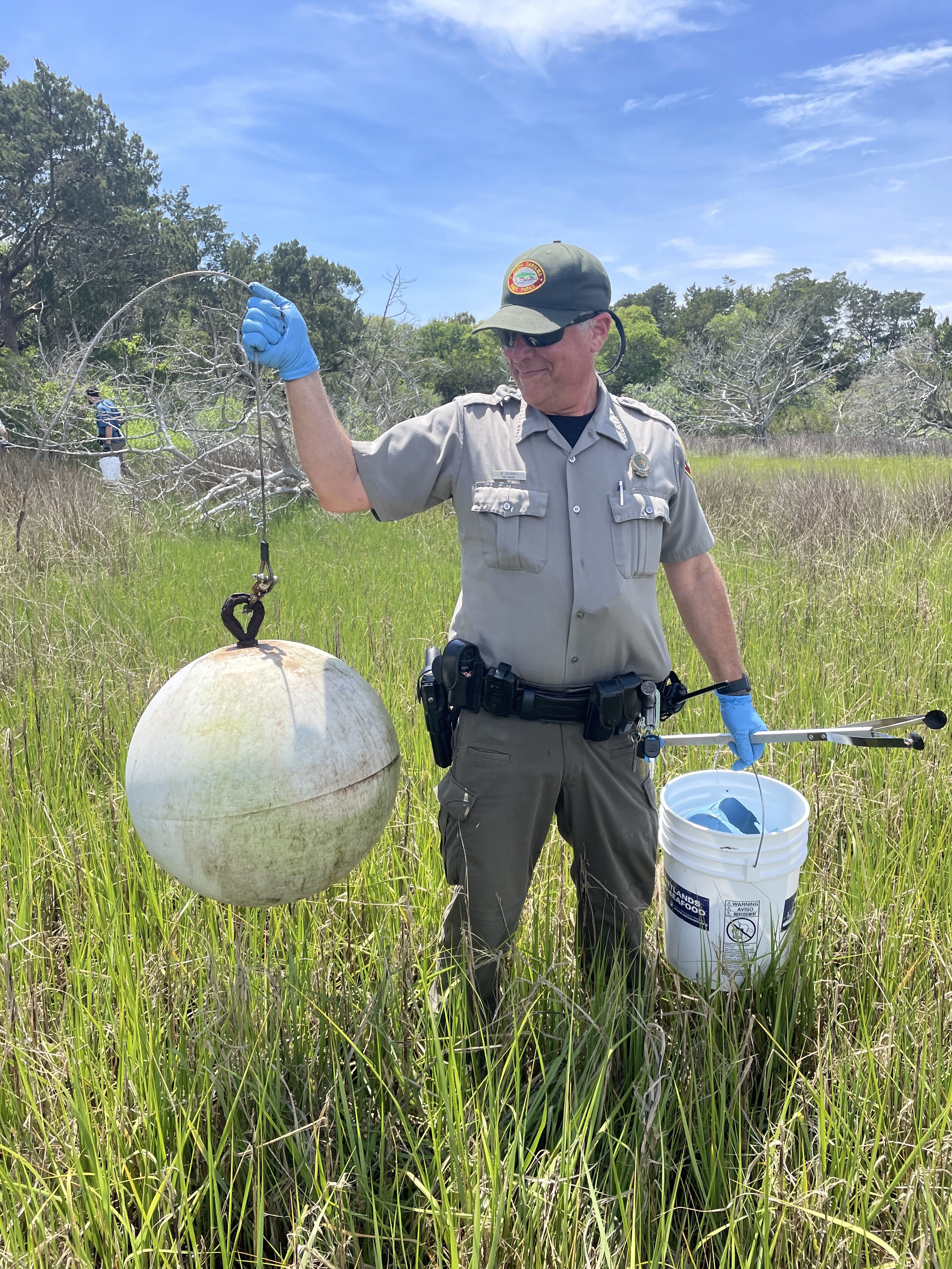 A Park Ranger at Fort Macon State Park holds up a piece of marine debris found during a clean up.